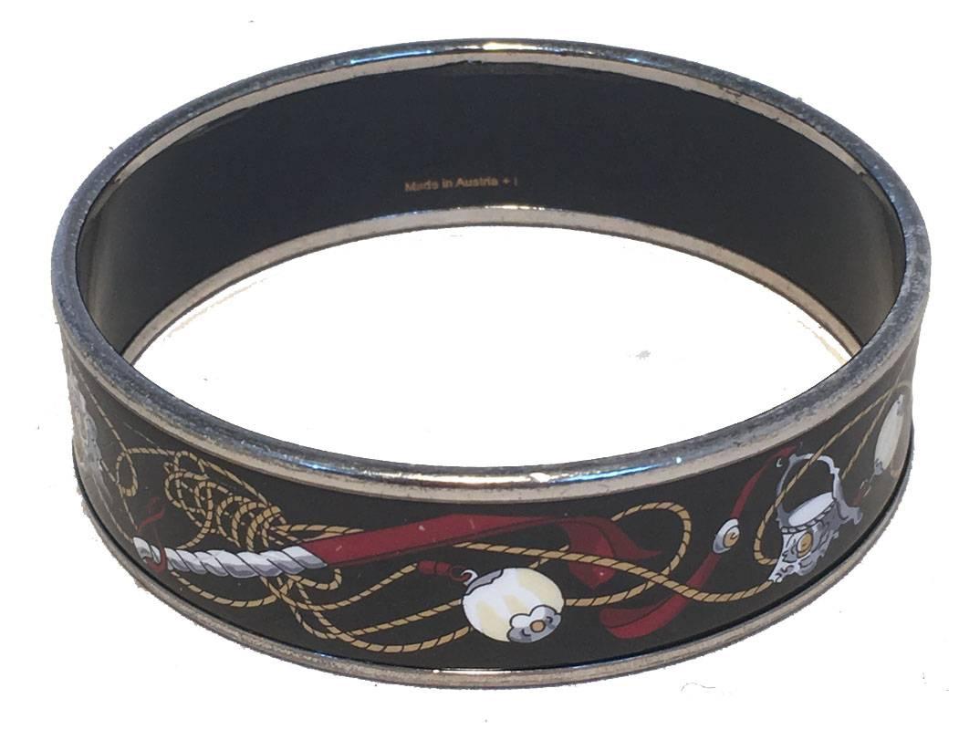 BEAUTIFUL Hermes vintage black printed enamel bangle bracelet in very good condition.  Black enamel medium width style with mutlicolor whip and bridle print trimmed with silver palladium hardware.  Light wear consistent with age and use.  Silver is