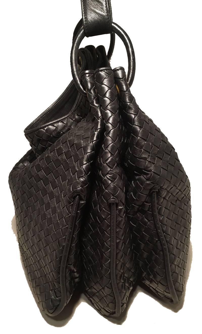 BEAUTIFUL Bottega Veneta black leather shoulder bag in excellent condition.  Signature style woven black leather exterior with a buckled shoulder strap.  3 pleated interior pockets fully lined in tan suede. Center pocket with zippered closure.  Back