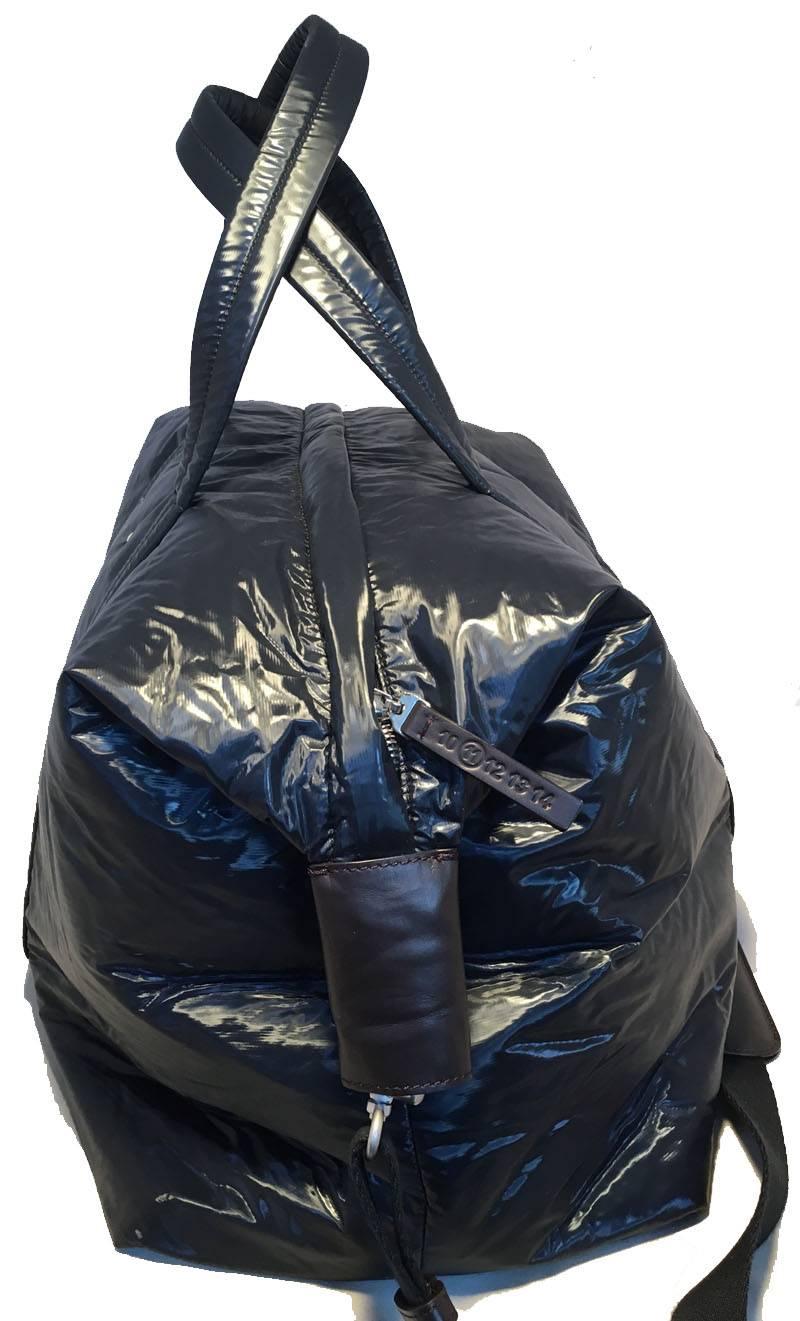 NWOT Maison Margiela navy vinyl tote in excellent condition.  Navy blue vinyl exterior with a ghostly slight iridescent sheen to it. black nylon shoulder strap and brown leather trim.  Top zipper closure opens to a brown lined interior that holds 1