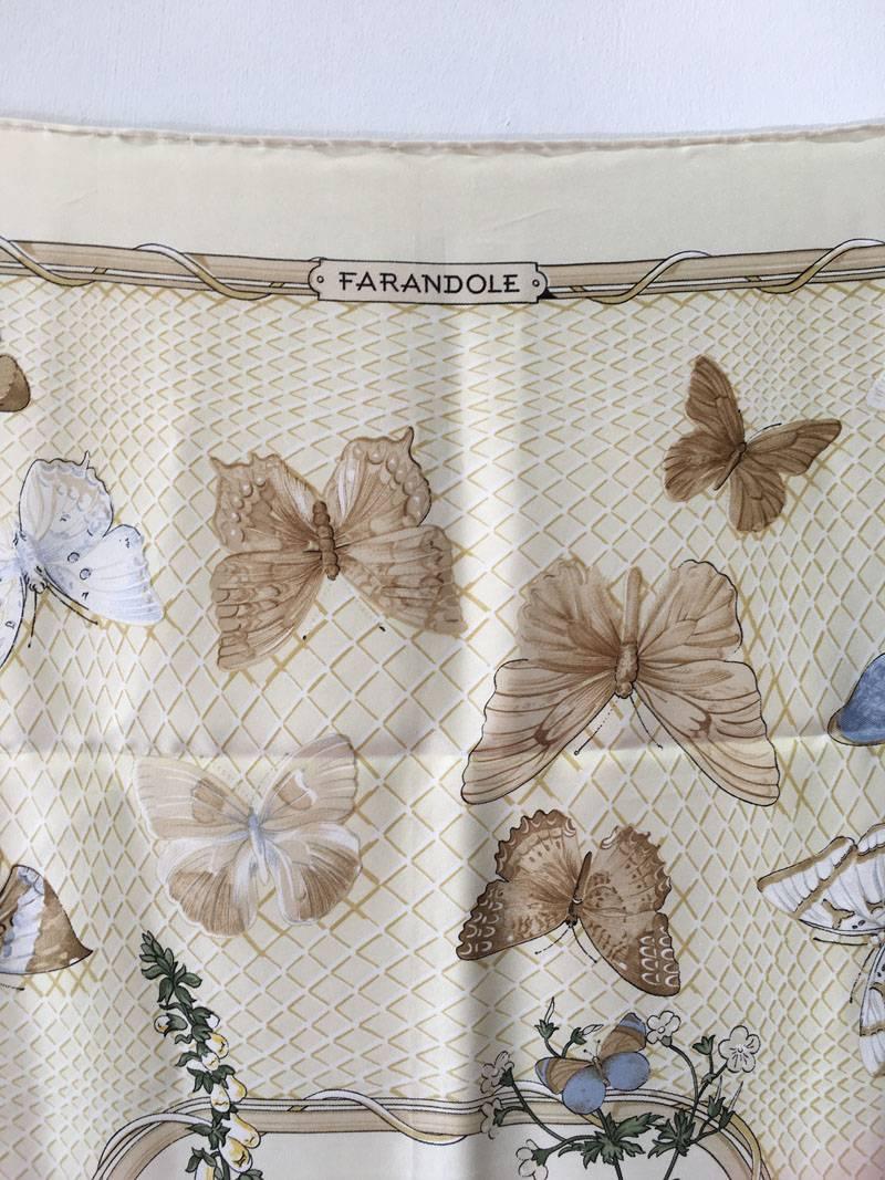 GORGEOUS HERMES vintage Farandole silk scarf in excellent condition.  Original silk screen design c1988 by Caty Latham features a beautiful array of multicolored butterflies over a cream background with a criss-cross web like design and solid