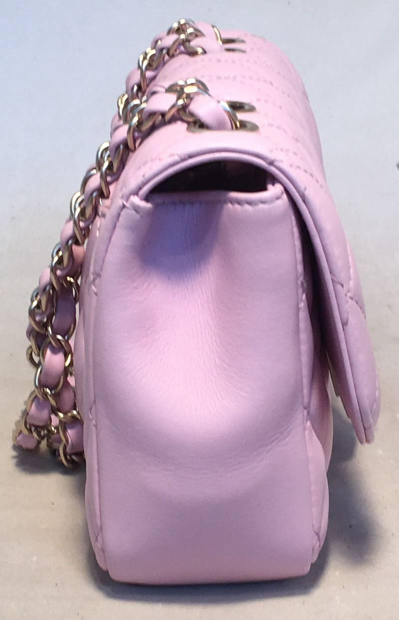 BEAUTIFUL Chanel lilac classic flap in excellent condition.  Lilac quilted lambskin leather exterior trimmed with matte gold hardware and signature woven chain and leather shoulder strap.  Front CC twist CC logo closure opens to a lilac fabric