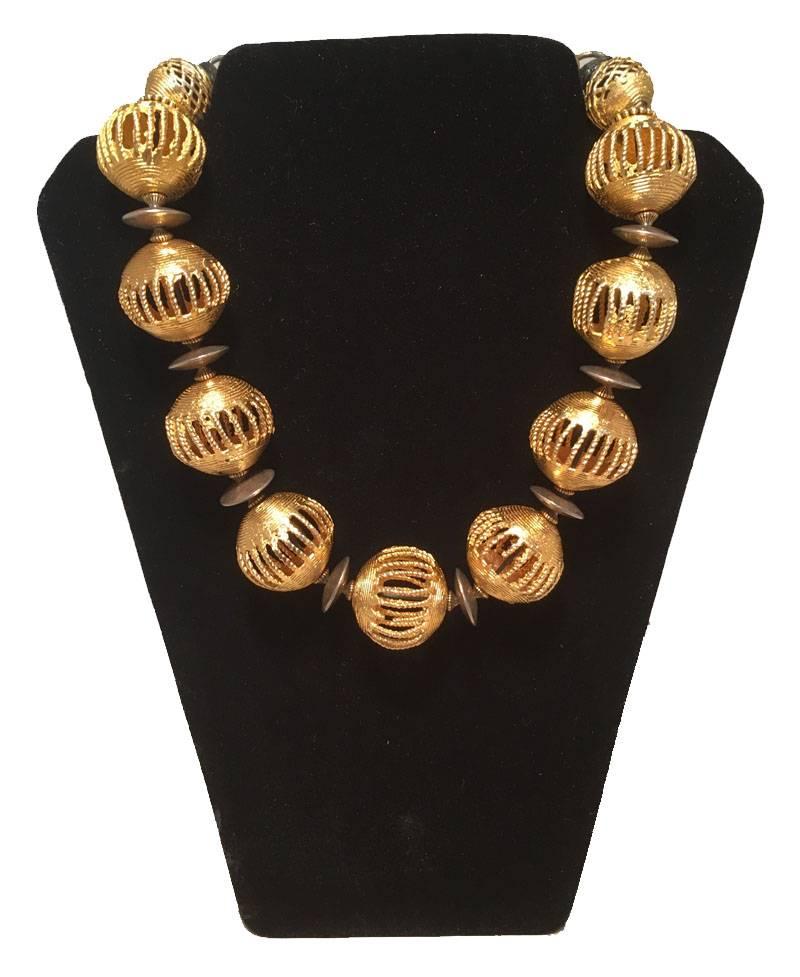 BEAUTIFUL Masha Archer necklace set in excellent vintage condition. One gold hollow ball necklace separated by brass disk beads. adjustable back clasp closure and signed charm. 2nd necklace features hollow golden balls 1.25