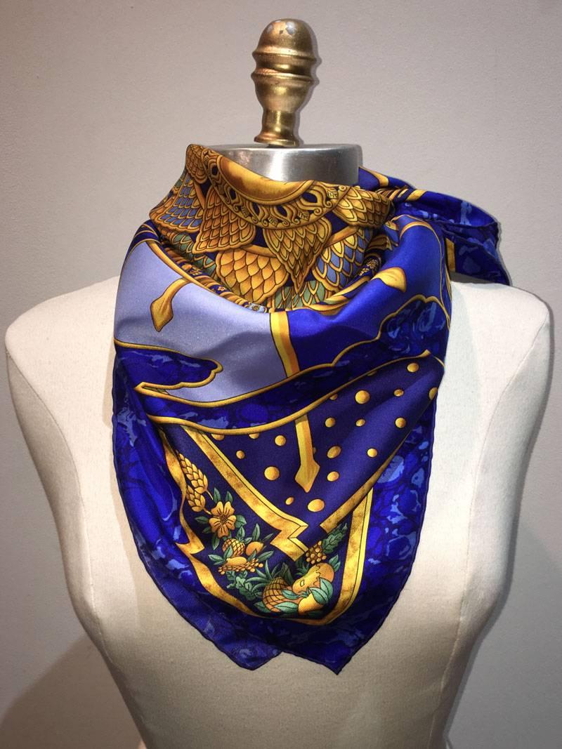 RARE Hermes Carpe Diem Silk scarf in excellent vintage condition. Original silk screen design c1994 by Joachim Metz features a beautiful intricate sunburst centered design with a mythological theme throughout. Marbled blue background with gold and