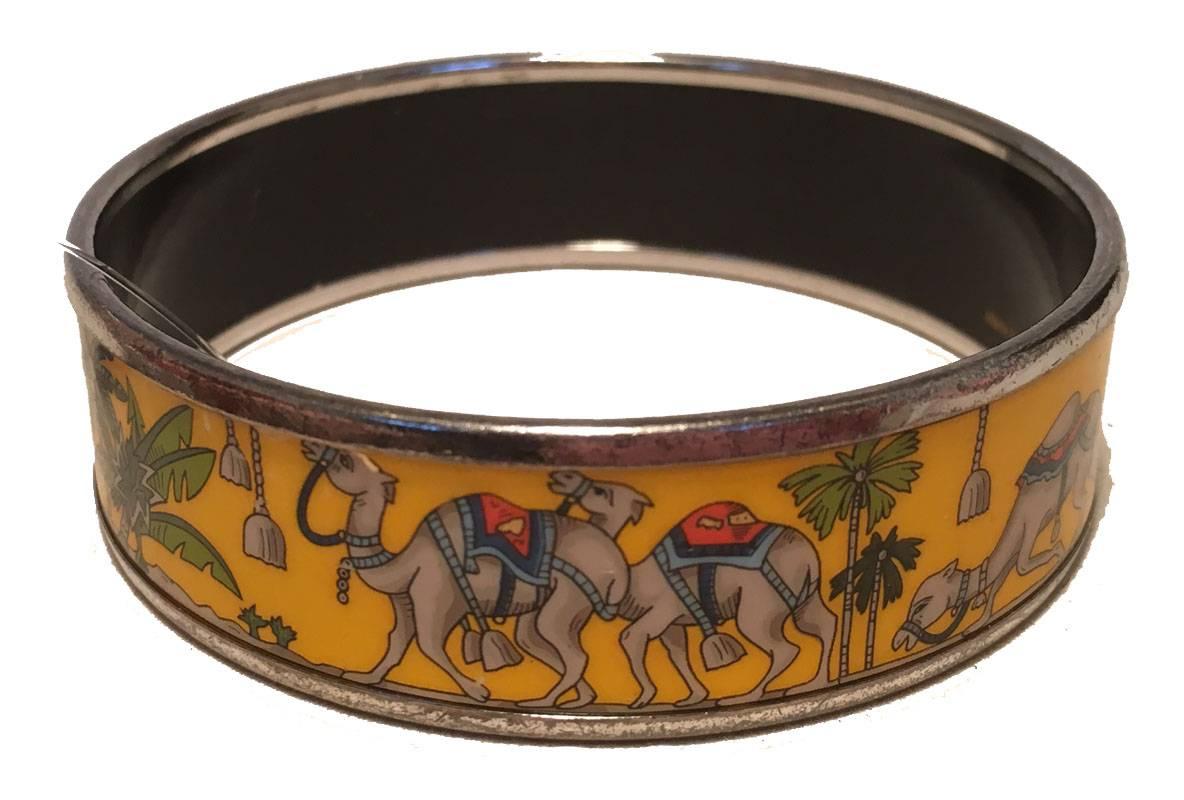 AMAZING Hermes vintage desert scene yellow enamel bangle bracelet in very good condition.  Yellow background with palm trees and camel print desert scene throughout.  Silver hardware surrounds.  Made in Austria, K stamp.  Light wear throughout