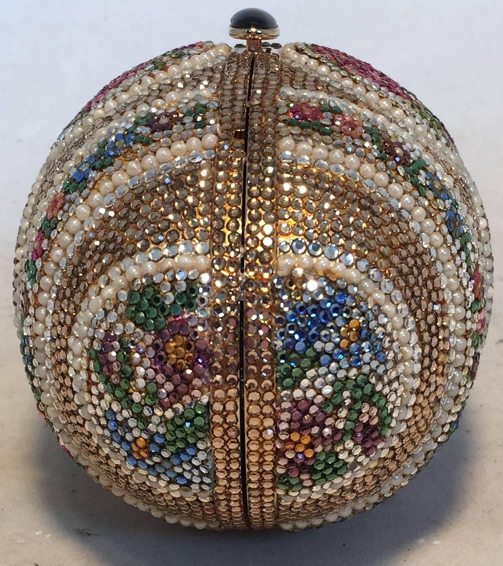 GORGEOUS Judith Leiber swarovski crystal egg minaudiere in excellent condition. Multicolor swarovski crystal design with delicate pearl details.  Button closure opens to a gold leather interior with separate compartments and attached gold chain