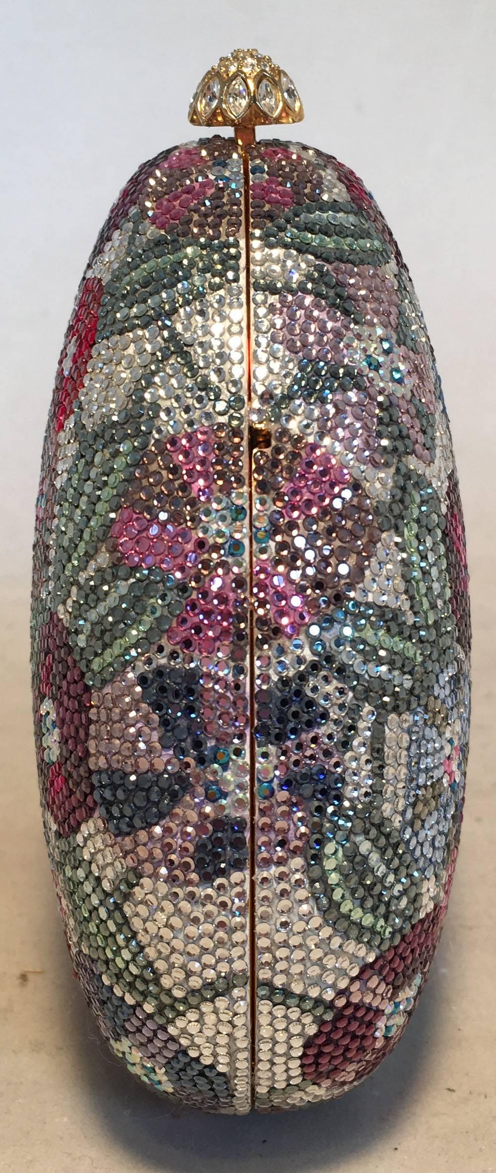 BEAUTIFUL Judith Leiber Swarovski Crystal floral print minaudiere in excellent condition. Teal Swarovski crystal background with multicolor floral print design throughout. Top crystal push button closure opens to a gold leather lined interior that