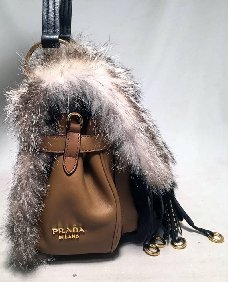 AMAZING NWOT Prada Fox Fur and Tan Leather Shoulder Bag in excellent condition.  Natural grey fox fur top and back exterior trimmed with black leather top handle, tan leather body and brass hardware.  Unique Leather and brass ringlet dangling
