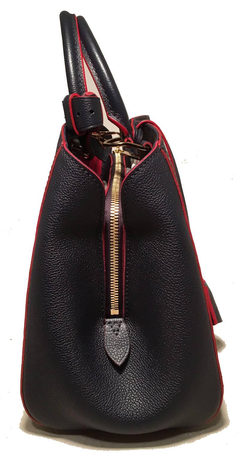 NWOT Louis Vuitton Navy Empreinte Leather Monogram Montaigne MM Handbag in excellent condition.  Navy blue embossed monogram empreinte leather with red trim and gold hardware.  Double handles and removable matching navy shoulder strap.  Leather