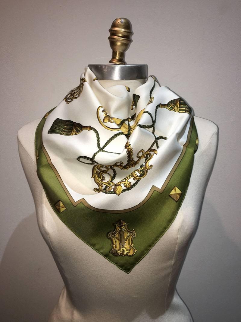 Classic Hermes Vintage les cles keys silk scarf in excellent condition.  Original silk screen design c1965 by Cathy Latham features an arrangement of various golden keys over a white background surrounded by a green border.  100% silk, hand rolled