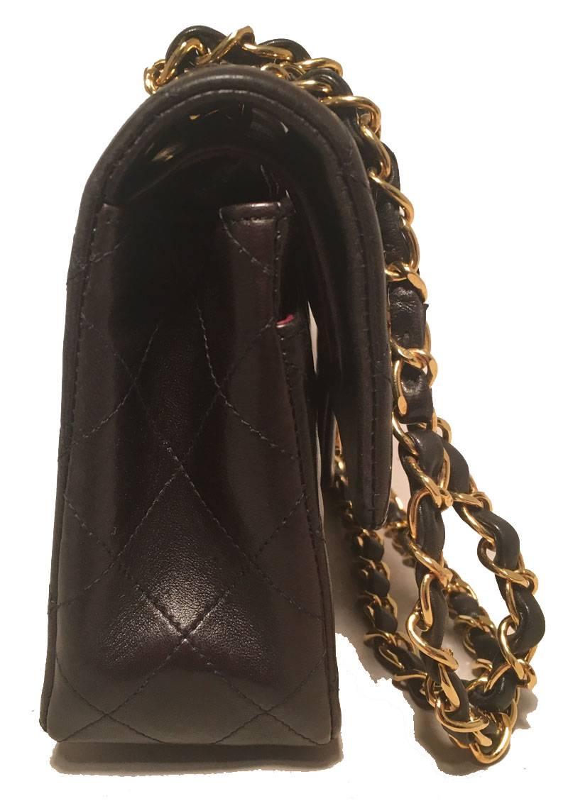 TIMELESS Chanel black brown 9inch 2.55 double flap classic in very good condition. Quilted lambskin leather exterior trimmed with gold hardware and a woven chain and leather shoulder strap. Front CC logo twist closure opens via double flap to a