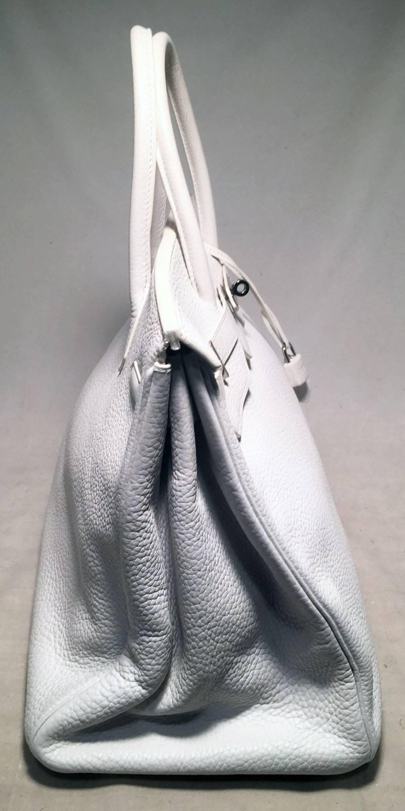 GORGEOUS Hermes White Togo leather 40cm Birkin Bag in excellent condition. White togo leather exterior trimmed with silver palladium hardware. Front twist double strap closure opens to a white kidskin lined interior that holds the perfect amount of