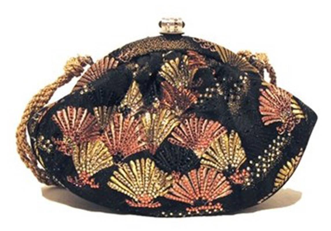 Authentic Judith Leiber silk and swarovski evening bag in MINT condition. Black silk exterior with multi-color embroidered fans that are embellished with swarovski crystals. Silver lift latch closure opens to a purple satin lined interior with one