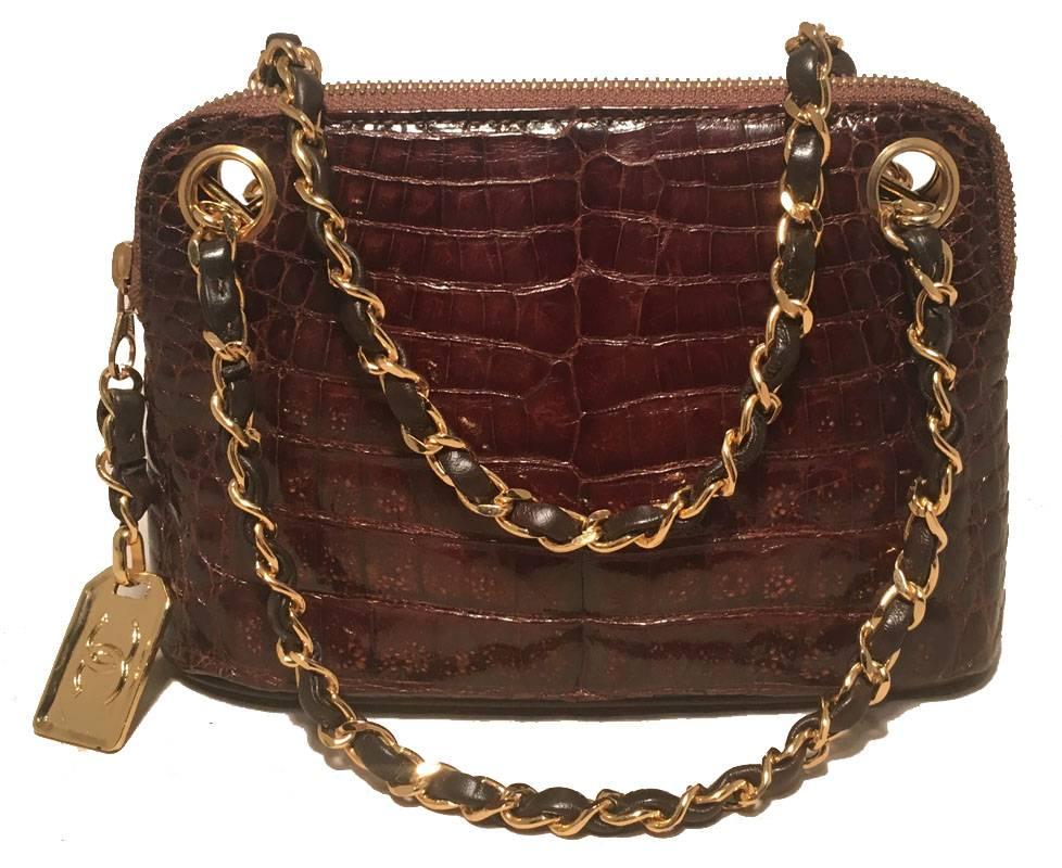 RARE Chanel Vintage Brown Alligator Mini Handbag in very good condition.  Brown alligator leather exterior trimmed with gold hardware and signature chain and leather handles.  Top zipper closure opens to a brown leather interior that holds 1 side