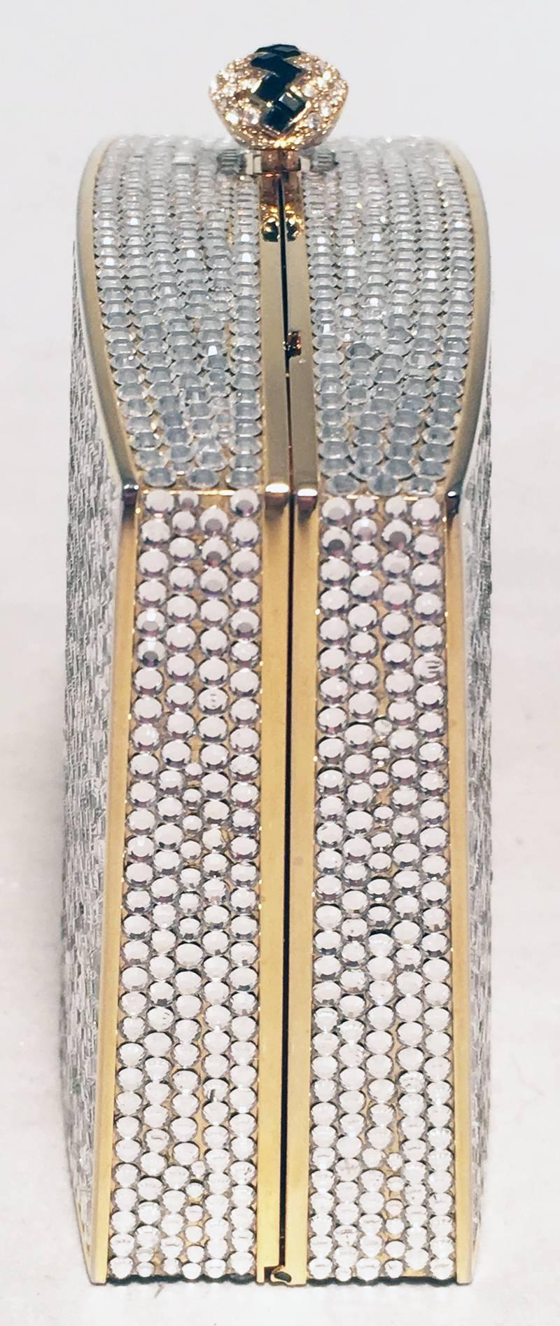Judith Leiber Clear Swarovski Crystal Minaudiere Evening Bag Clutch in excellent condition.  Clear swarovski crystal exterior over a gold solid form body.  Top embellished crystal button closure opens to a gold leather lined interior that holds an
