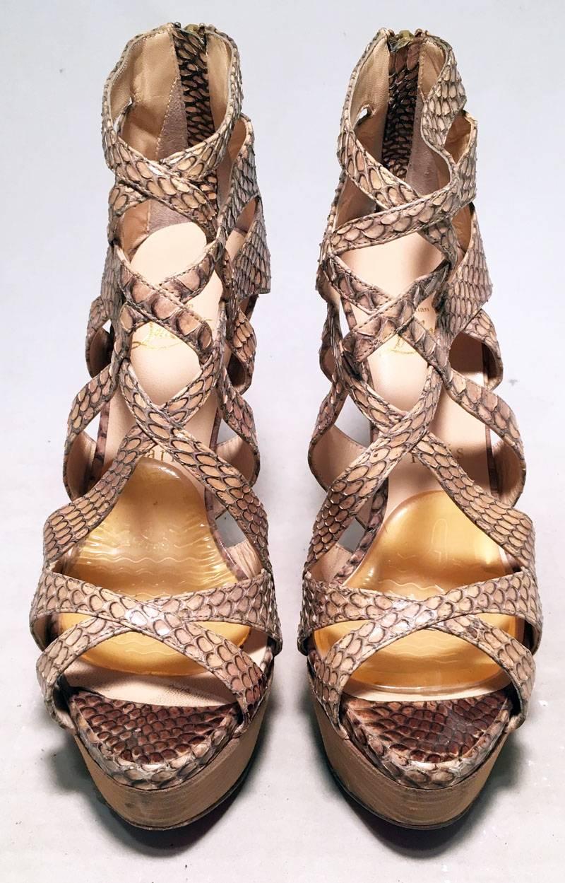 Christian Louboutin Natural Tan Snakeskin Python Cut Out Stiletto Heels in good condition.  Natural tan python snakeskin upper in unique cut out peek a boo style with tan leather insole.  Signature red soles with tan wood look leather platform heel.