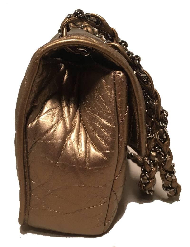 Chanel Quilted Bronze Leather Classic Flap Shoulder Bag in excellent condition. Quilted distressed bronze leather trimmed with woven silver chain and bronze leather wrapped shoulder strap.  front flap closure opens via snap closure to a white nylon
