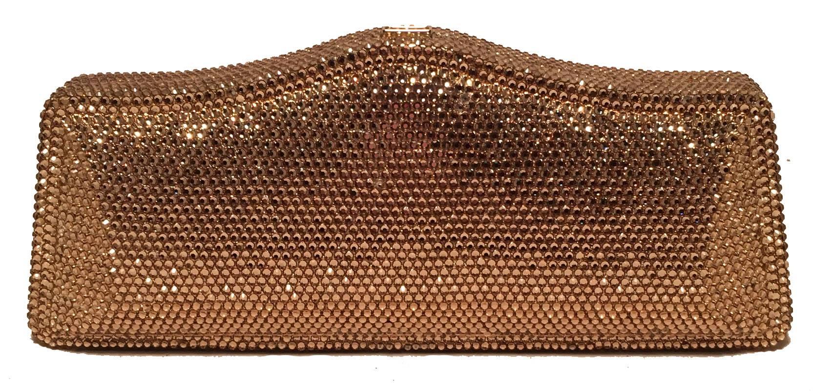 Judith Leiber Gold Swarovski Crystal Evening Bag Minaudiere Clutch in excellent condition.  Gold swarovski crystal exterior trimmed with a top button closure that opens to a gold leather lined interior.  Removable gold chain shoulder strap attached