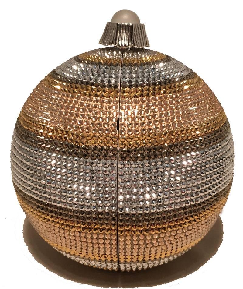 Beautiful Judith Leiber Swarovski Crystal Stripe Ball Minaudiere Evening Bag in excellent condition.  Striped gold, silver, and bronze swarovski crystal exterior trimmed with silver hardware and a top button closure.  Silver leather interior holds a