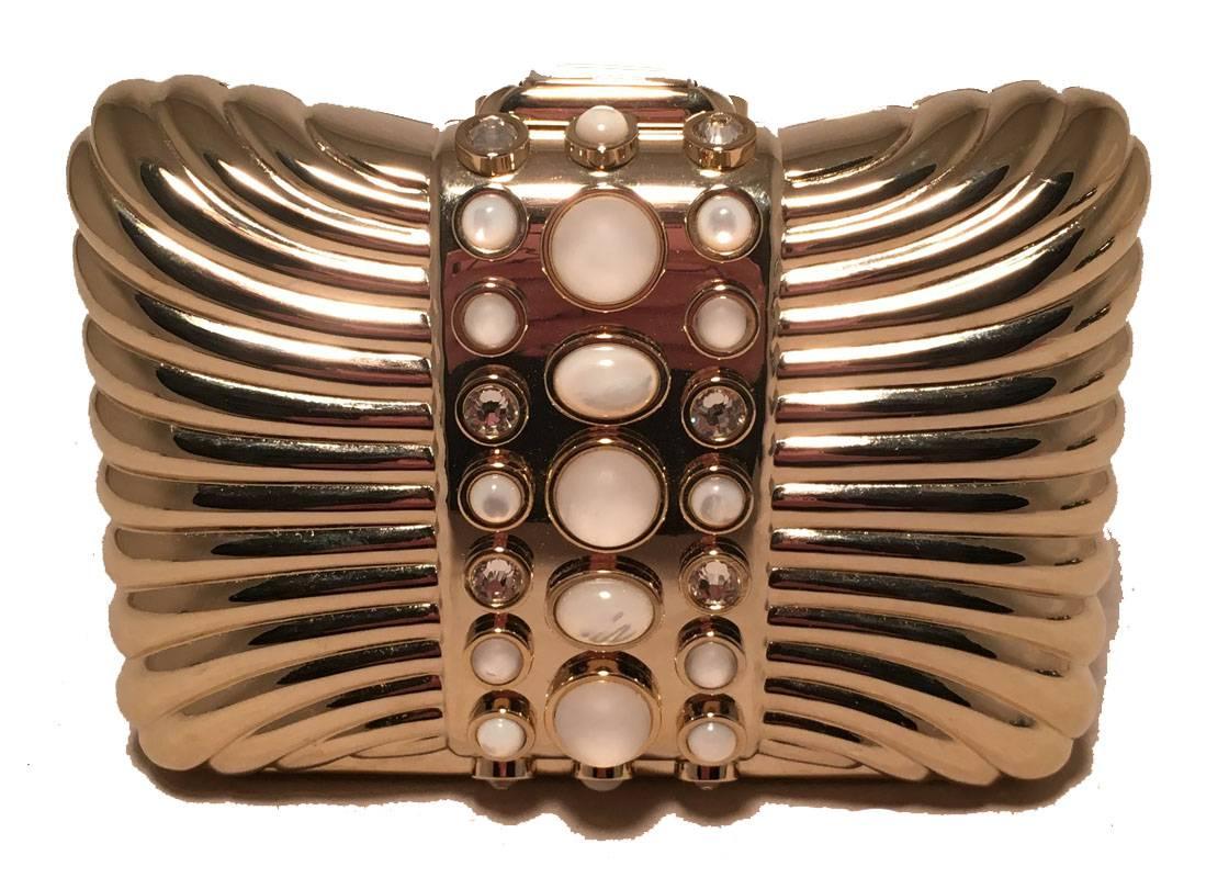 gorgeous Judith Leiber Vintage Gold Box Clutch with Pearl Details in excellent condition.  Gold box body with clear crystal and pearl stone details.  top button closure opens to a gold leather interior that holds an attached gold chain strap to