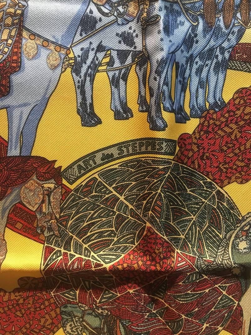 AMAZING Hermes Art de Steppes silk pocket square in excellent condition.  Original silk screen design c1991 by Annie Faivre features an equestrian theme with multiple dressed show horses over intricately designed patterns and yellow background. 100%