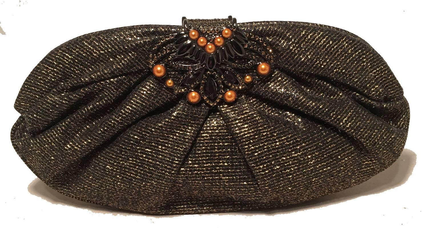 FABULOUS Judith Leiber Black and Gold Woven Pearl Embellished Clutch in excellent condition.  Black nylon woven with gold thread trimmed with embellished closure featuring orange pearls and gunmetal hardware.  Purple silk lined interior holds 1 side