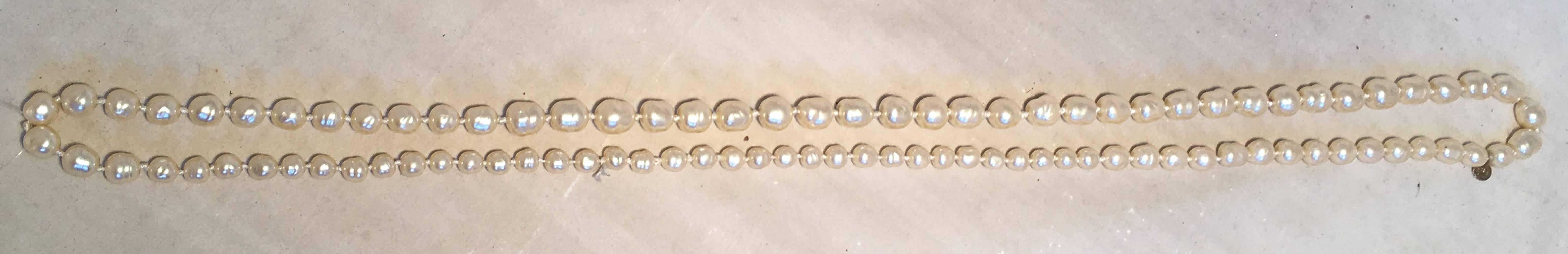 Classic Chanel strand of pearls long necklace in excellent vintage condition.  Each pearl has a unique natural shape. Pearls vary in size from about 1/4