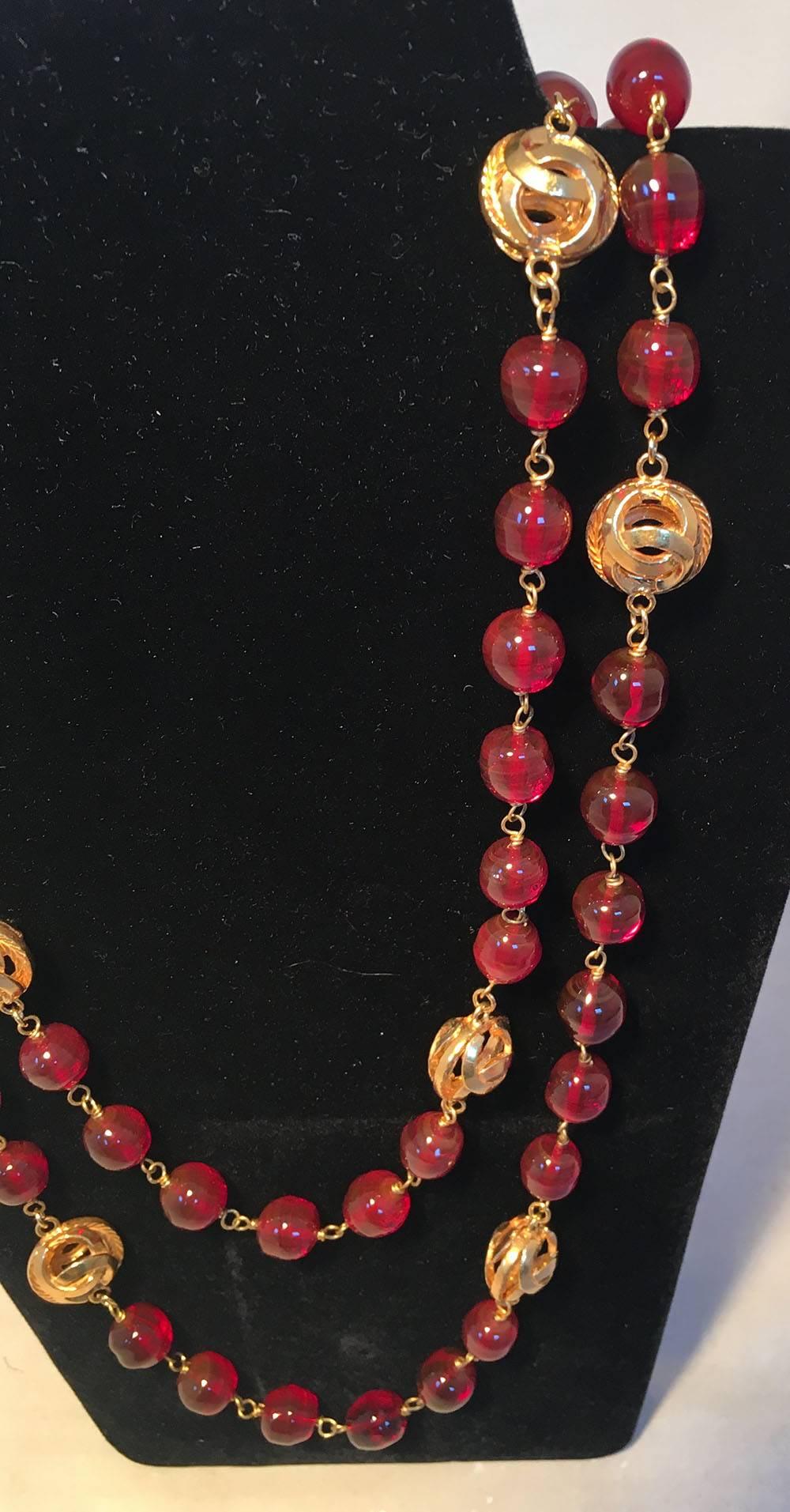 GORGEOUS Chanel Dark Red and Gold CC Beaded Long Necklace in excellent condition.  Dark red glass beads with larger gold CC logo cut out beads strung throughout. Spring ring closure. Original logo made in France charm attached. No scuffs, scratches,