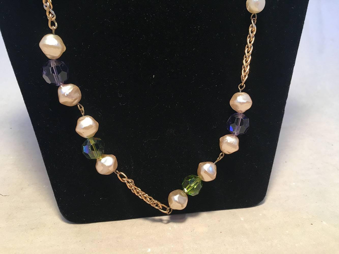 AMAZING Chanel Vintage Pearl and Green and Purple Beaded Necklace with Crystal Ball in good condition.  Gold link chain necklace with large pearl beads, green and purple crystal beads and a centered large rhinestone crystal ball detail featuring the