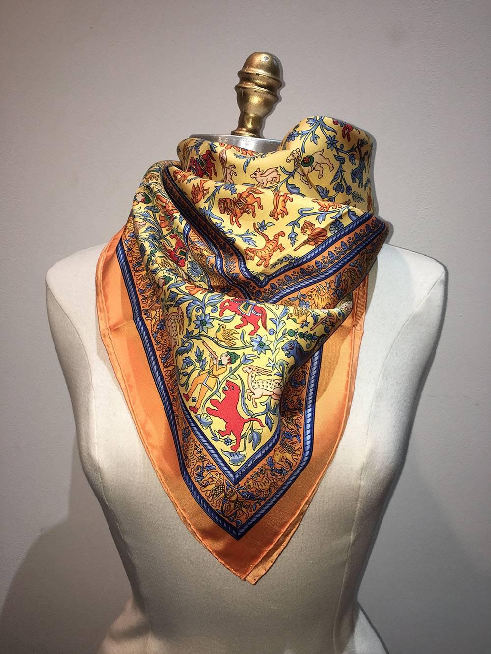 FABULOUS Hermes Vintage Chasse en Inde Silk Scarf in Orange in excellent condition. Original silk screen design c1986 by Michel Duchene features an intricate design depicting hunting in India over a yellow and orange background and border. 100%