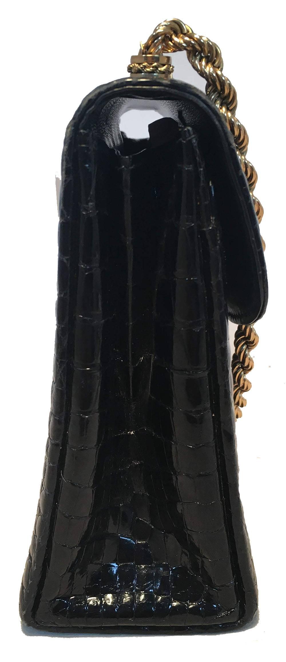 FABULOUS Gucci Vintage Black Alligator Handbag in excellent condition.  Black alligator exterior trimmed with gold chain handle and front folding latch closure. Single flap style closure opens to a black leather lined interior that holds 2 slit and