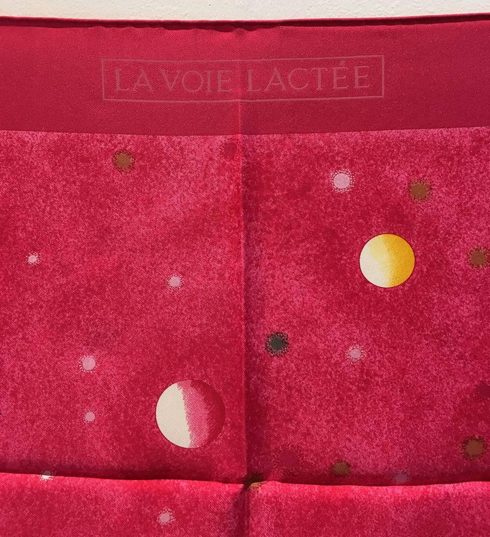 Beautiful Hermes La Voie Lactee Silk Scarf in Dark Pink in excellent condition.  Original silk screen design c1999 by Wlodzimierz Kaminsky features an astronautical themed print with planets, stars, and the milky way galaxy over a dark pink