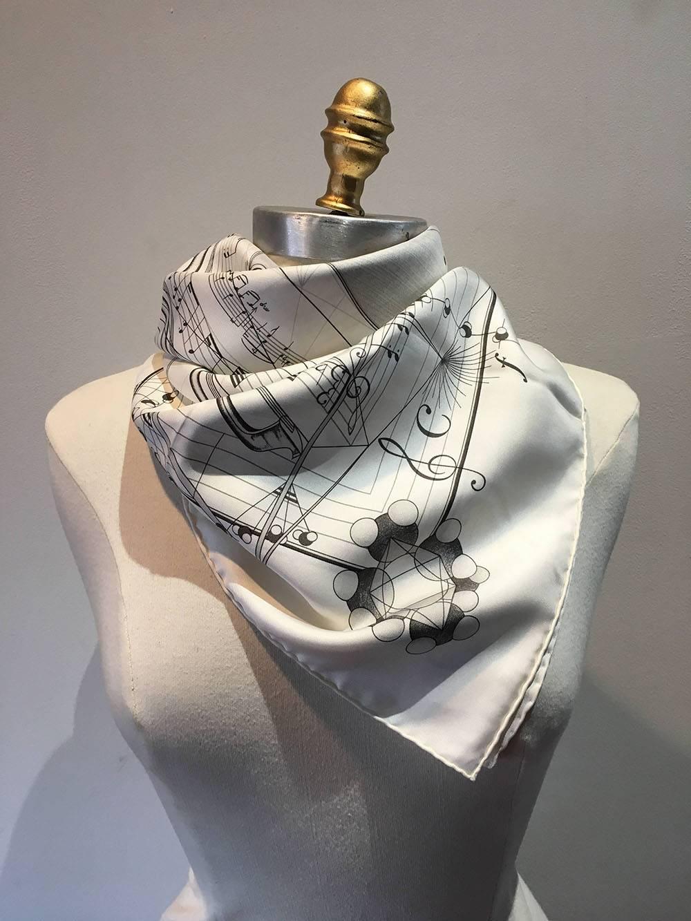 CLASSIC Hermes La Musique Des Spheres White Silk Scarf c1996 in excellent condition. Original silk screen design c1996 by Zoé Pauwels features a black sketch style rendering centered Violin design surrounded by music notes, lines, clefs, and other
