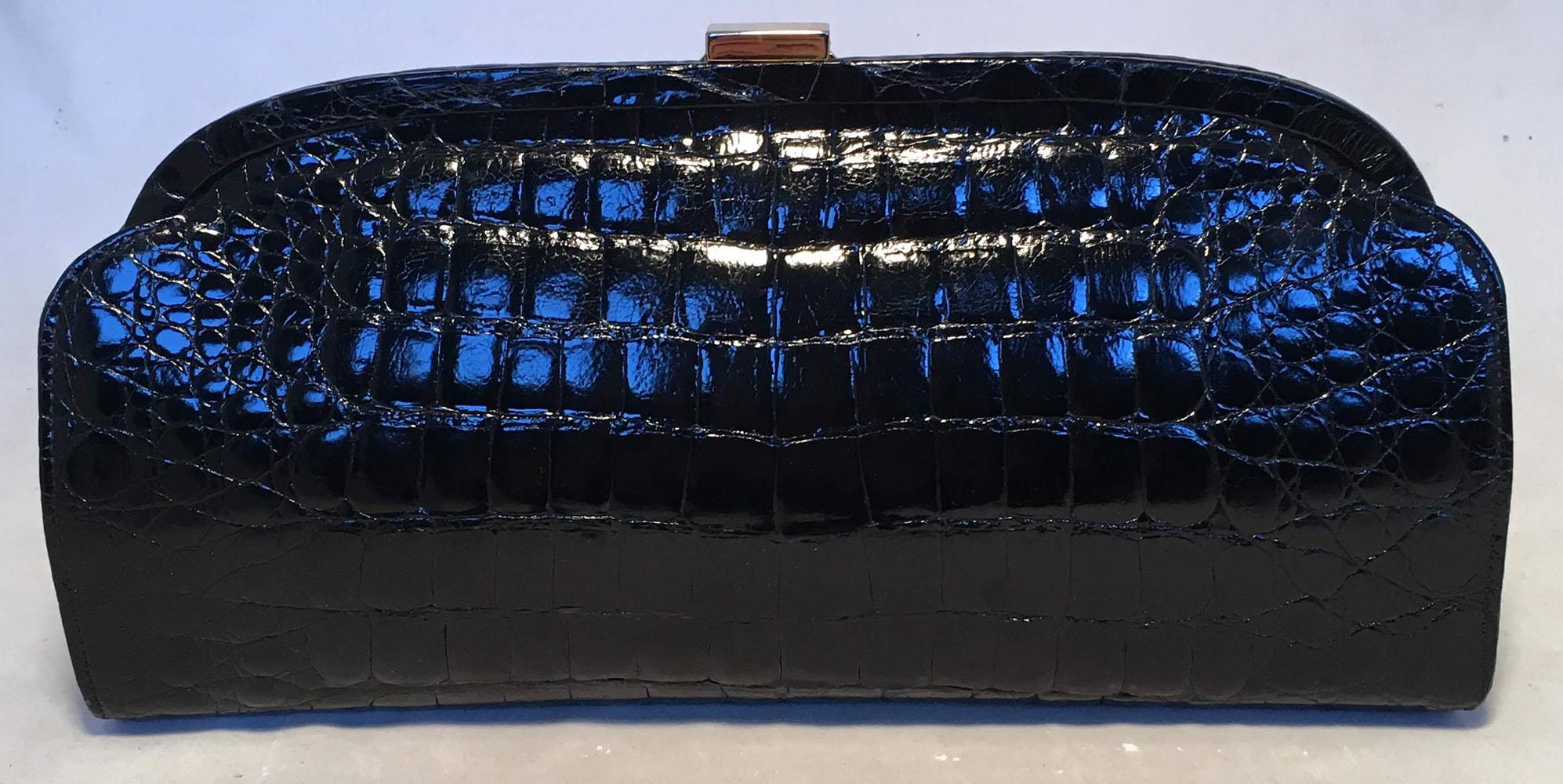 CLASSIC Vintage Vero Black Crocodile Italian Clutch in excellent condition.  Black crocodile leather trimmed with gold hardware. Lifting top closure opens to a black leather interior that holds one slit and one zippered side pockets and an attached