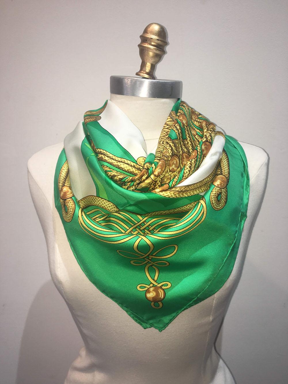 CLASSIC Hermes Vintage Brandebourgs Silk Scarf in Green c1970s in very good condition. Original silk screen design by Caty Latham c1972 features a traditional military jacket in kelly green adorned with golden ropes and buttons. White background