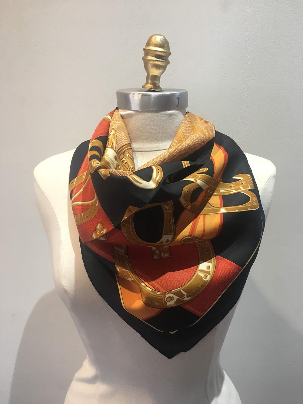 RARE Hermes Vintage Porte Bonheur Silk Scarf in Black in very good condition. Original silk screen design c1976 features an assortment of lucky horseshoes over a black background with a centered tan and gold crown diamond pattern design and red and