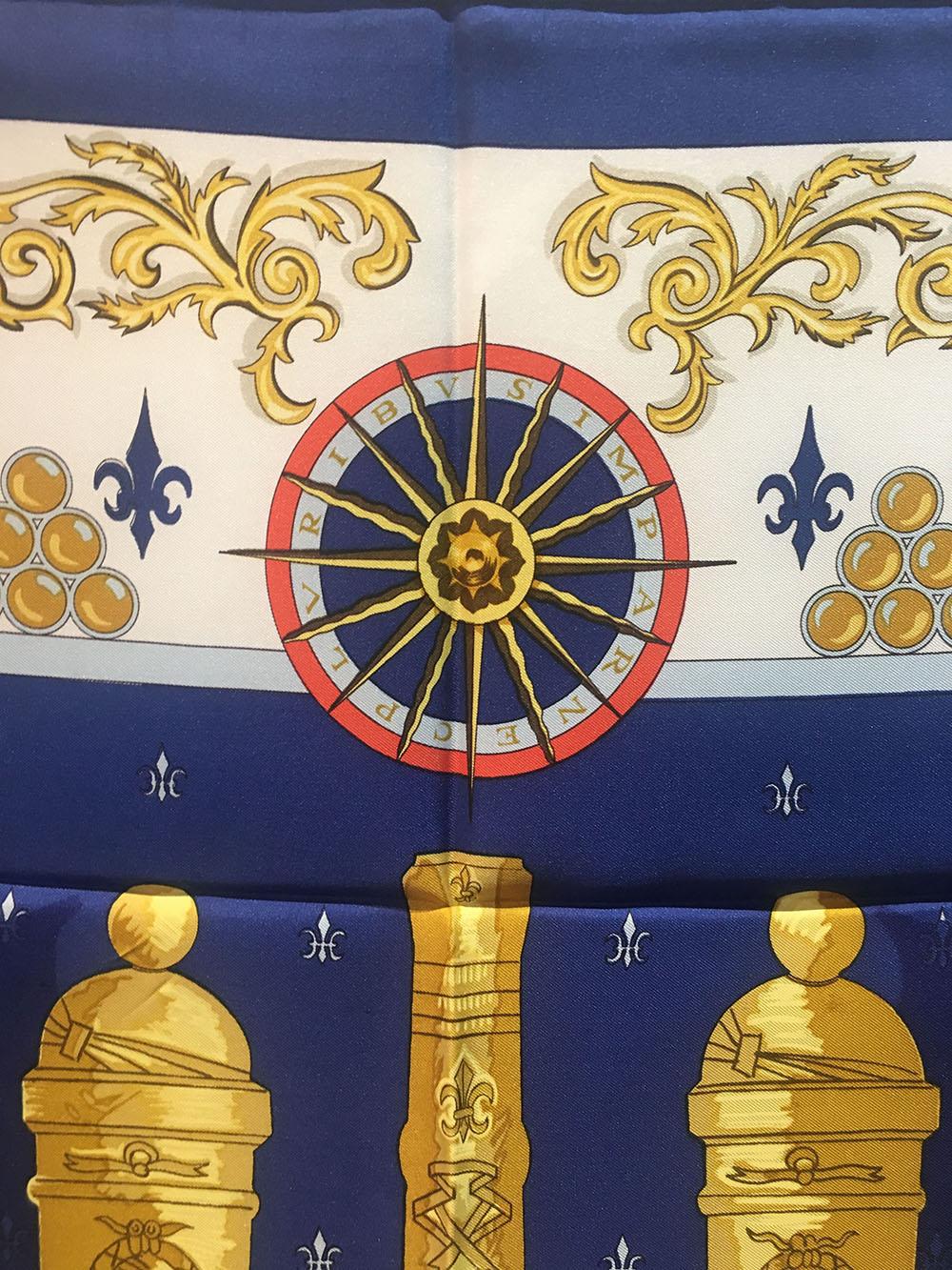 RARE Hermes Vintage Le Canon Du Soleil Royal Silk Scarf in Navy in excellent condition. Original silk screen design by Pierre Peron features a centered artistic rendering of 5 golden embellished canons over a navy blue background surrounded by a