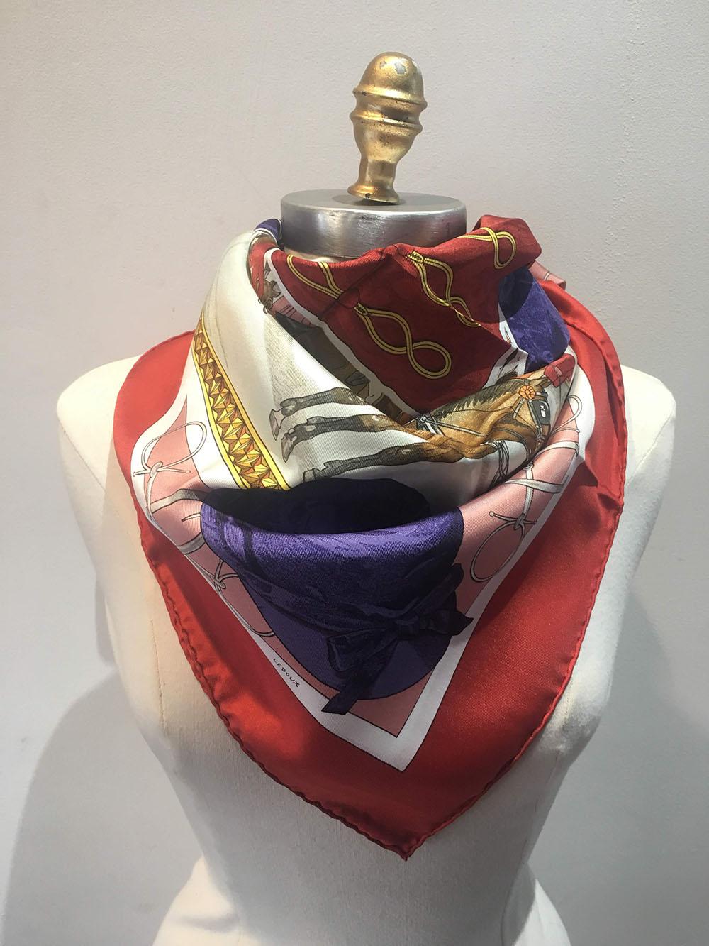 Hermes Vintage On Epsom Downs silk scarf in excellent condition. Original silk screen design c1970 by Phillipe Ledoux features the fields, horses and riders of the Epsom Downs horse track in England. Centered riding jacket in red and purple. 4