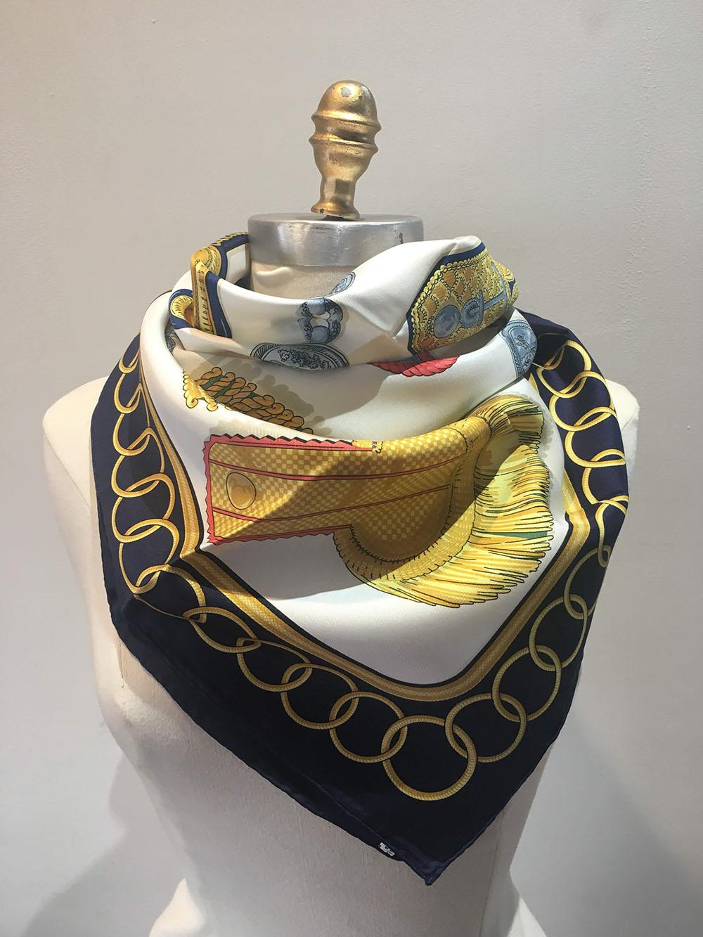 RARE Hermes Vintage Epaulettes silk Scarf c1970s in black in excellent condition. Original silk screen design c1975 by Caty Latham features 16 differently designed classic epaulettes in golds, greys, reds, and blues over a white background and
