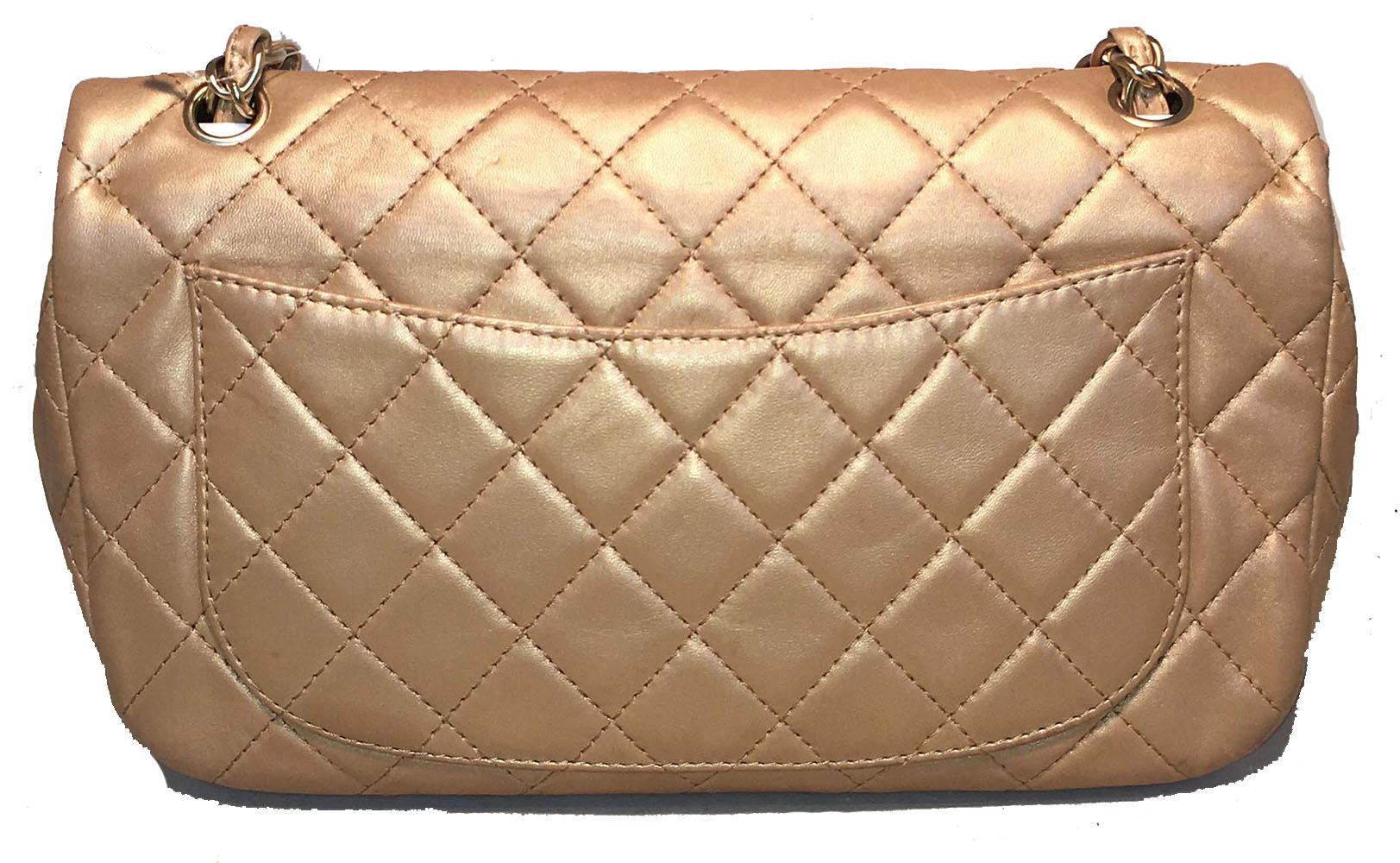 AMAZING Chanel gold leather gem logo closure classic flap shoulder bag in excellent condition. Quilted soft gold leather exterior trimmed with matte gold hardware, woven chain and leather doubled shoulder strap and gorgeous gem embellished front