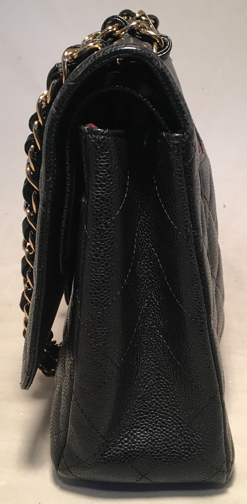 TIMELESS Chanel Black Quilted Caviar Maxi Classic Flap Shoulder Bag in excellent condition. Black quilted caviar leather exterior trimmed with gold hardware and signature woven chain and leather shoulder strap. Twisting CC logo closure opens via