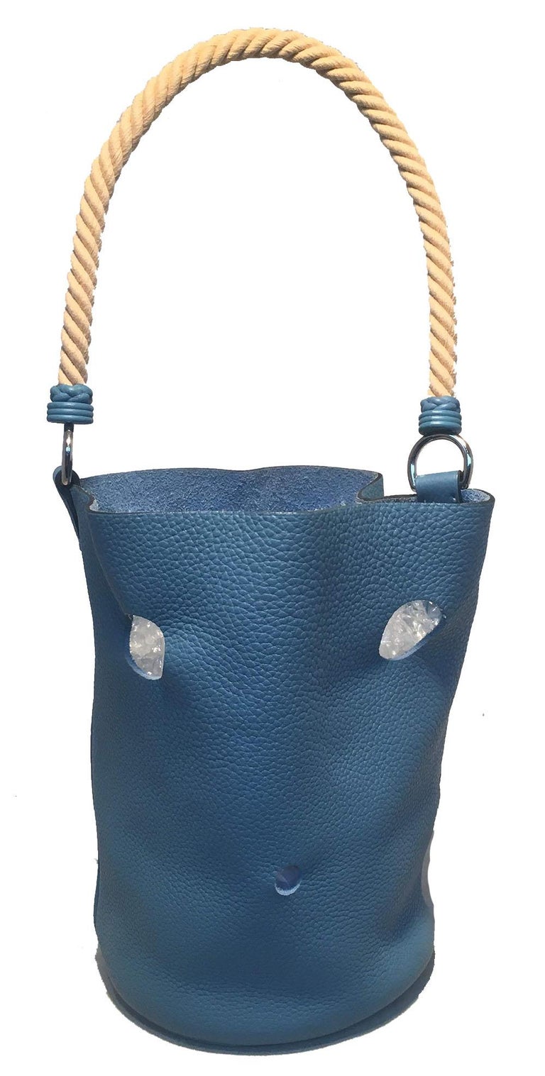 FABULOUS Hermes Blue Jean Taurillon Clemence Leather Mangeoire Rope handle bucket bag in excellent condition.  Blue jean clemence leather exterior trimmed with silver hardware and laser cut holes throughout. Top twisted natural beige rope handle.