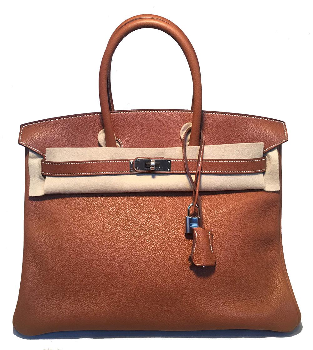 GORGEOUS NEW 2018 Hermes 35cm Tan Barenia Faubourg Leather Birkin Bag in excellent new unused condition. Tan barenia faubourg leather exterior with white topstitching and silver palladium hardware. Top twist double strap closure opens to a matching