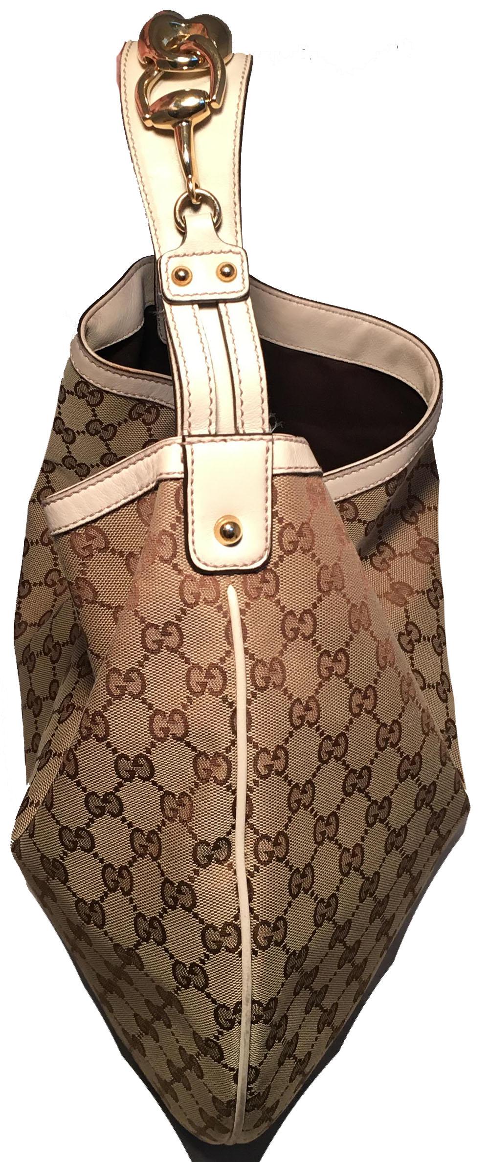 CLASSIC Gucci GG Monogram Canvas and Beige Leather Hobo Shoulder Bag in excellent condition. Monogram GG canvas exterior trimmed with beige leather and gold hardware. Deep interior pocket is lined with brown nylon and holds one zipped and one slit
