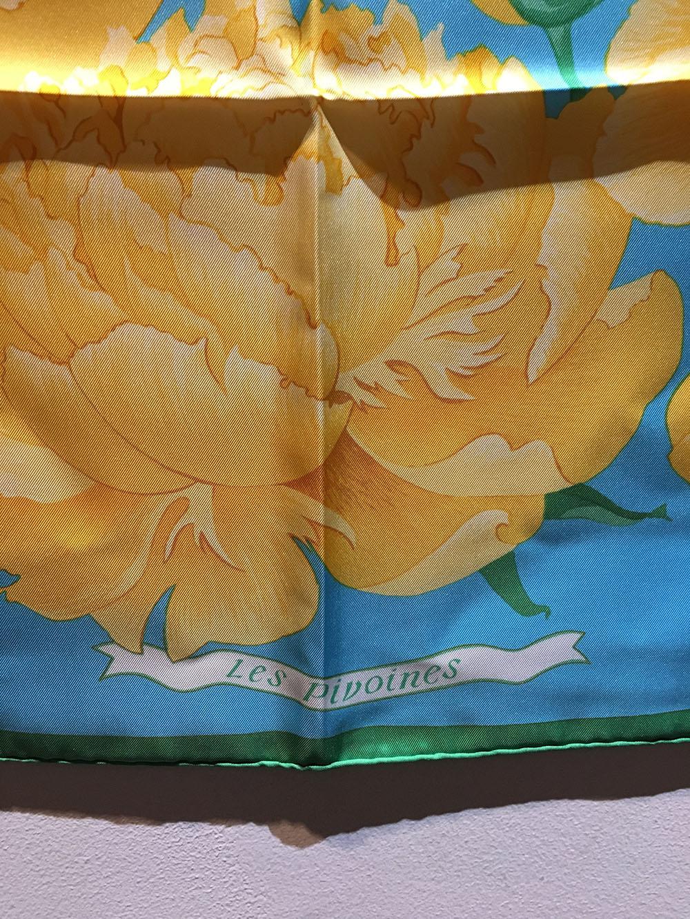 Hermes Vintage Les Pivoines Silk Scarf in excellent condition. Original silk screen design c1978 by Christiane Vauzelles features beautiful yellow peonies over a blue background surrounded by a thin green square border. 100% silk, hand rolled hem,