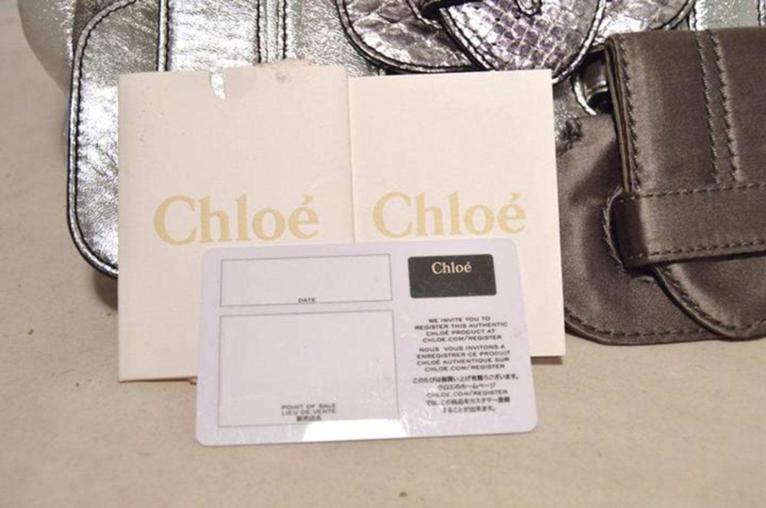 Fabulous CHLOE silver buckled shoulder bag in excellent condition. Silver leather, satin, and snakeskin exterior trimmed with a leather and satin shoulder strap and front flap design that features an arrangement of faux buckles. Front flap opens to