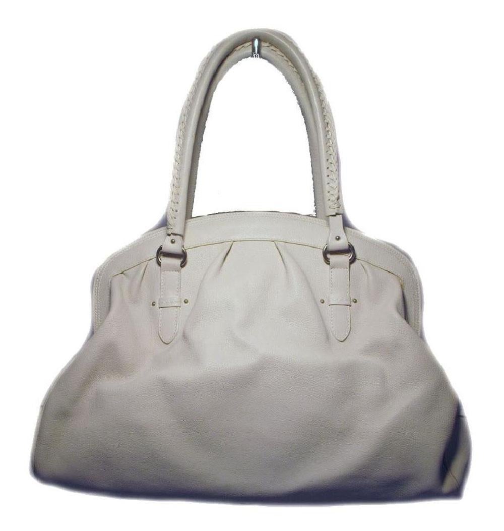 This stunning Christian Dior Shoulder bag is in good condition. The exterior features beautiful bone white leather trimmed with matte silver hardware. The double braided handles are not only extremely comfortable but also stylish. There are two
