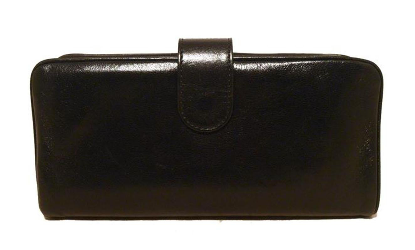 Beautiful Chanel black leather bow wallet clutch in excellent condition. Black lambskin leather trimmed with a delicate CC silver logo along the front bow side. Top lifting closure opens to a black leather interior that holds 7 credit card slits, 2