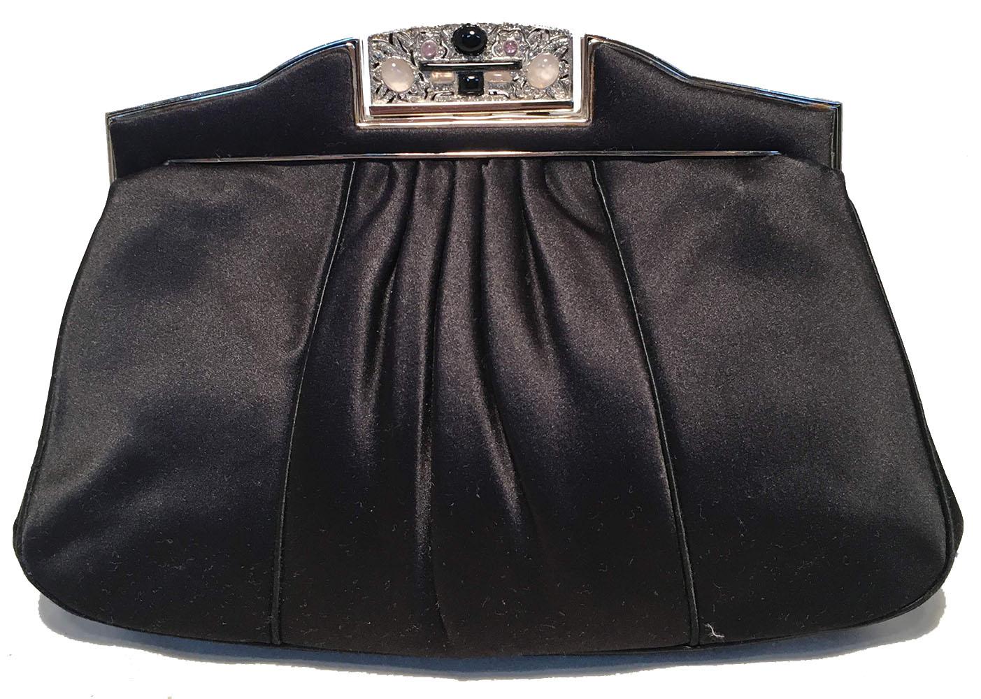 BEAUTIFUL vintage Judith Leiber black silk clutch in excellent vintage condition. Black pleated silk satin exterior trimmed with silver hardware. top lifting closure opens to a black silk lined interior that holds 1 slit and 1 zippered side pocket