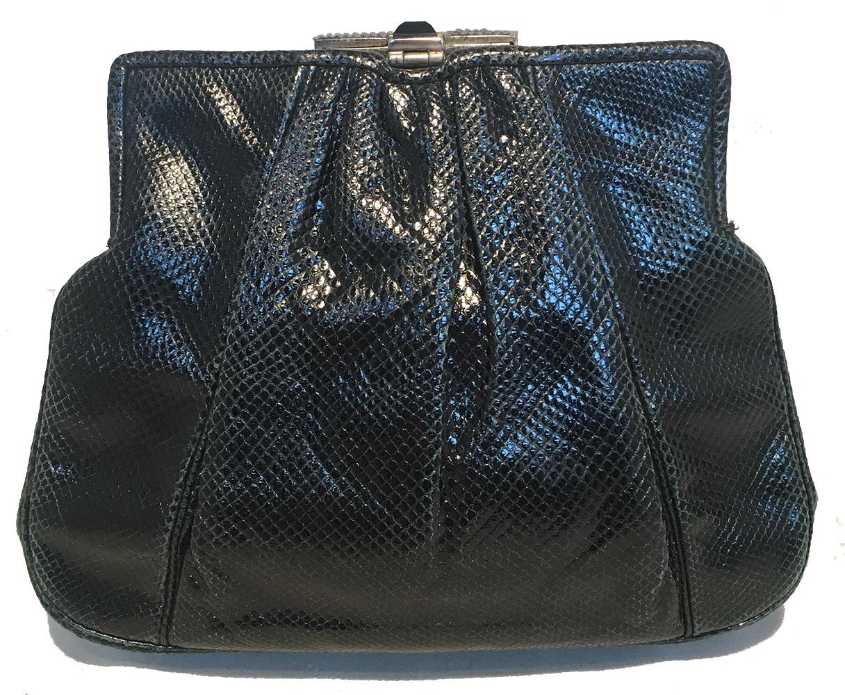 Judith Leiber Vintage Black Lizard Art Deco Embellished Top Clutch in very good condition. Black lizard leather exterior trimmed with silver hardware and an art deco style crystal and black enamel embellished top detail. Lifting top closure opens to