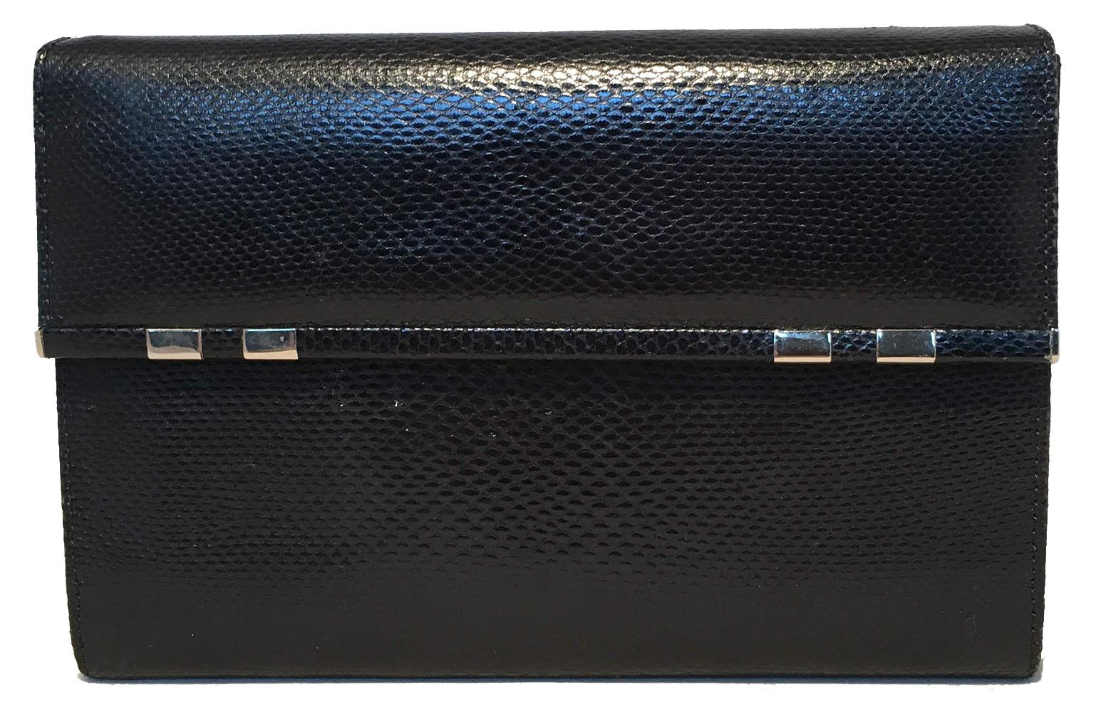 FABULOUS Judith Leiber Black Lizard Wallet Wristlet Clutch in excellent condition. Black lizard leather exterior trimmed with silver hardware and a removable strap. Double magnetic snap closure opens to a pink leather lined interior that holds 9